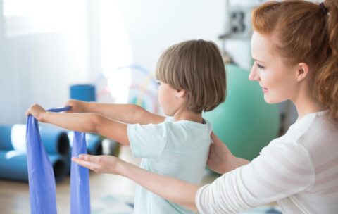 physiotherapist-supporting-kid.jpg