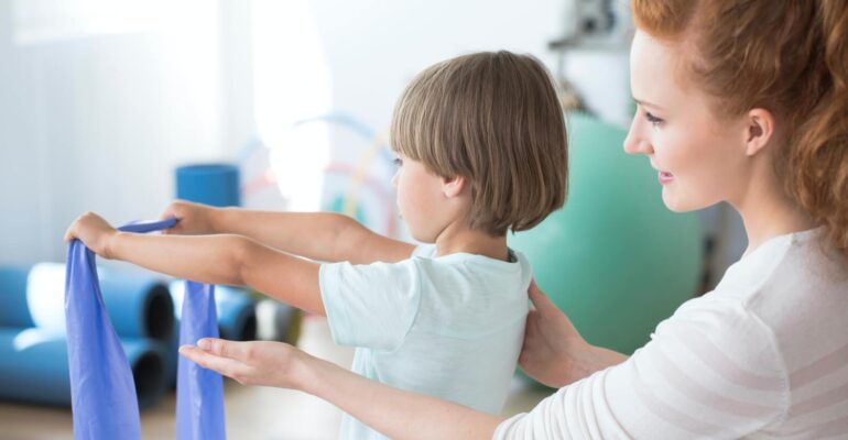 physiotherapist-supporting-kid.jpg